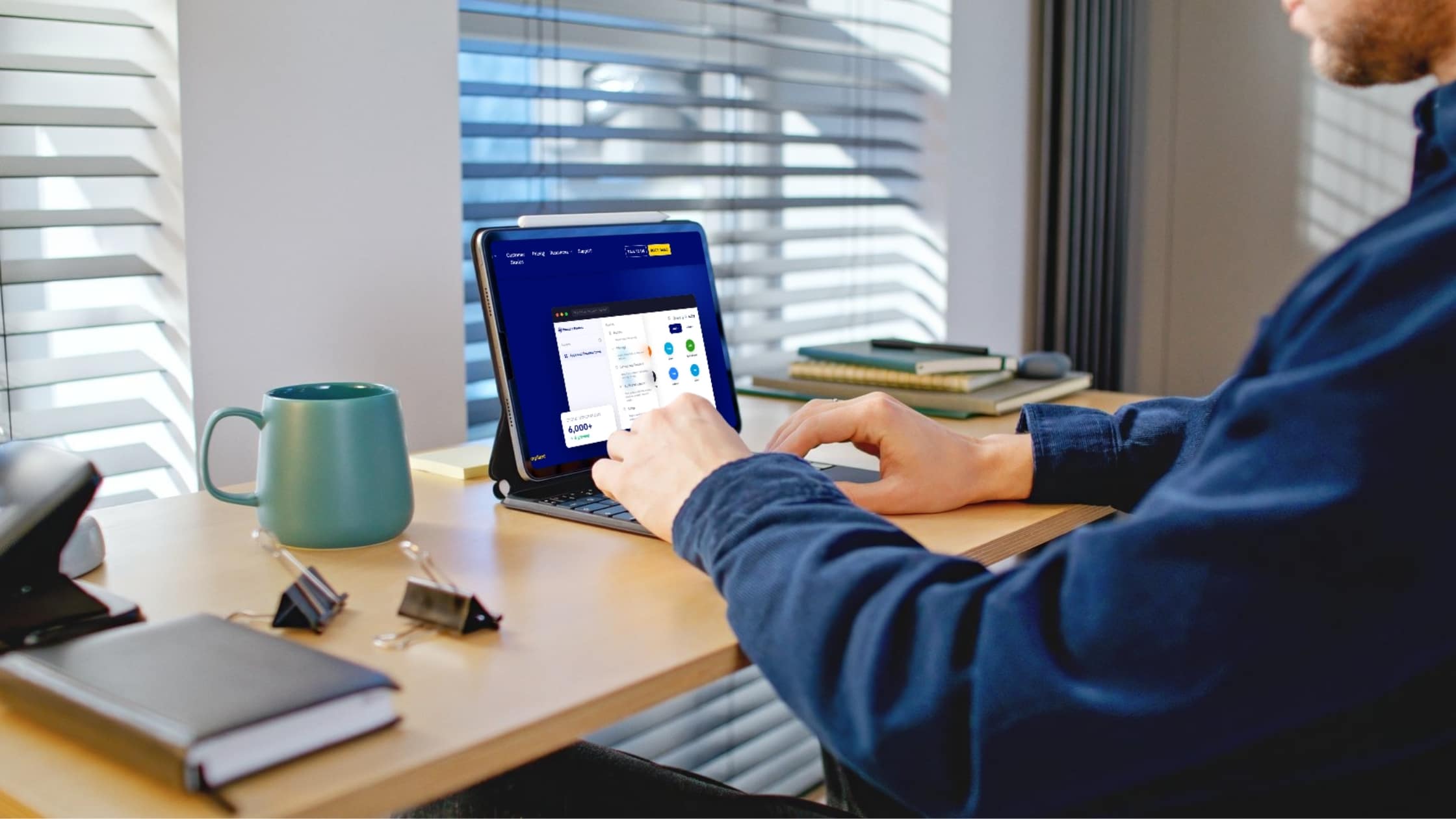 Practice owner using a tablet to manage security settings on the Practice Protect dashboard at his desk.